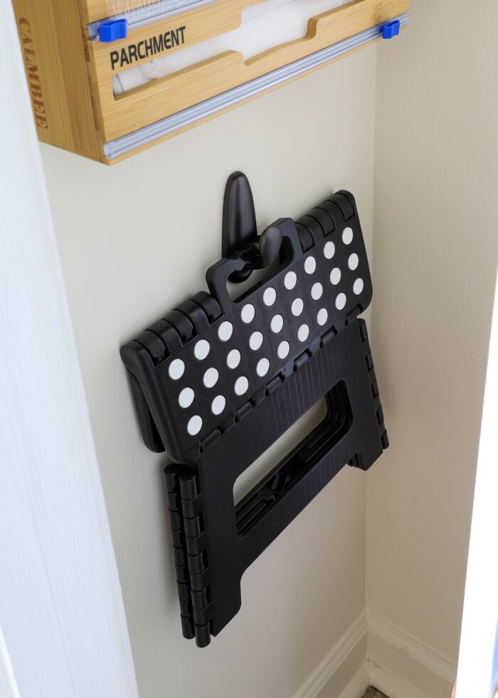 Hook inside pantry holding foldable stool