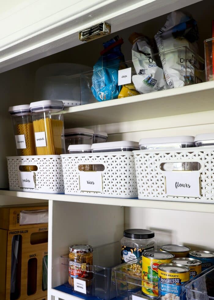 Upper shelf of pantry holding pastas, rices, and flours