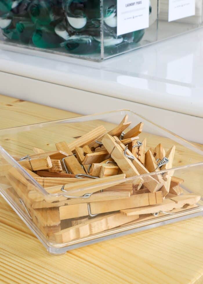 Clear tray of wooden clothespins