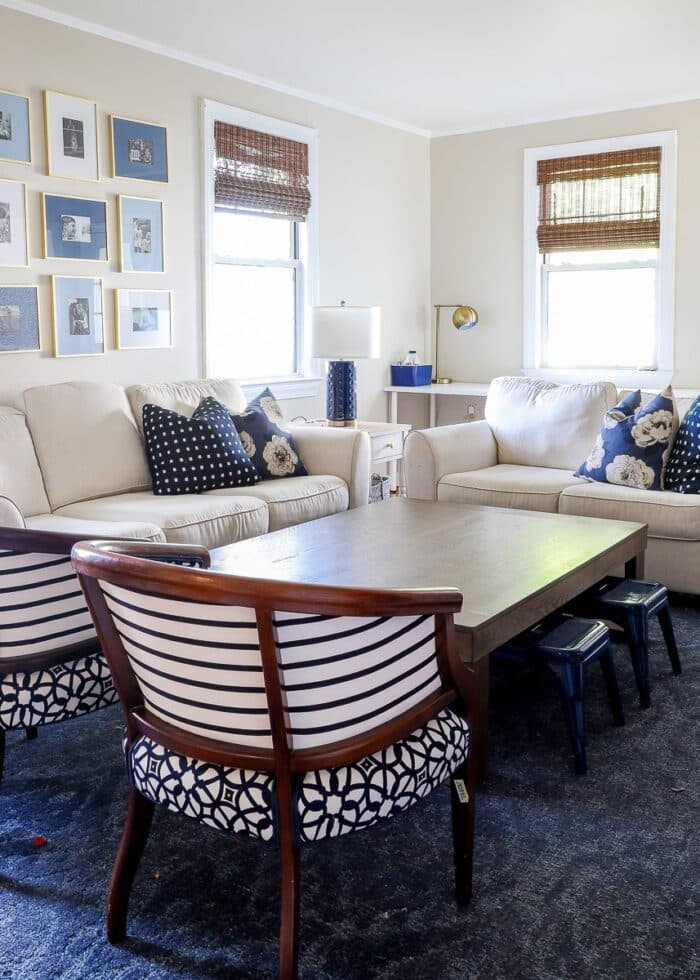 Blue, white, and beige family room with striped chairs and a large coffee table