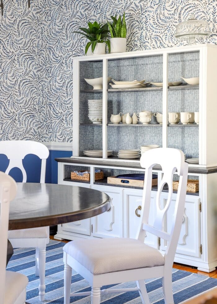 Blue and white dining room with hutch against the wall