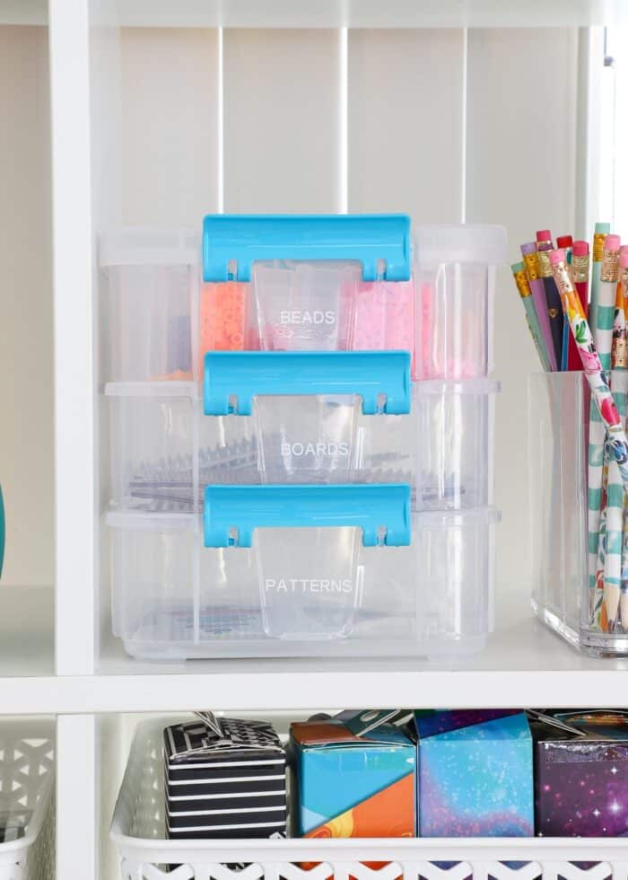 A plastic perler beads storage box on a white shelf