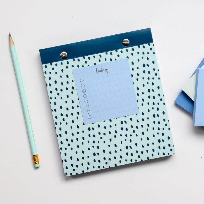A mini to do list printed onto a blue Post-It Note stuck to a dotted notebook