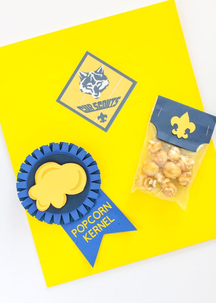 Yellow Cub Scout Folder with Popcorn Kernel Ribbon and sample on top