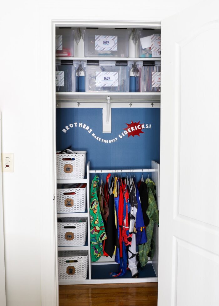 Kids closet with school memory boxes on top shelf