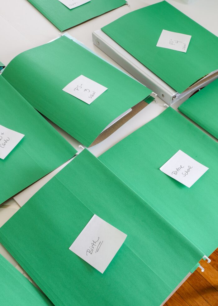 Green file folders with sticky note temporary labels