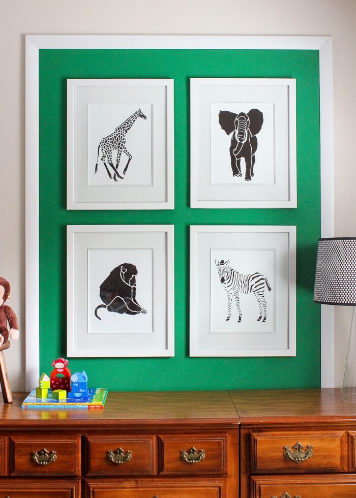 Green fabric applied to wall with white frames on top