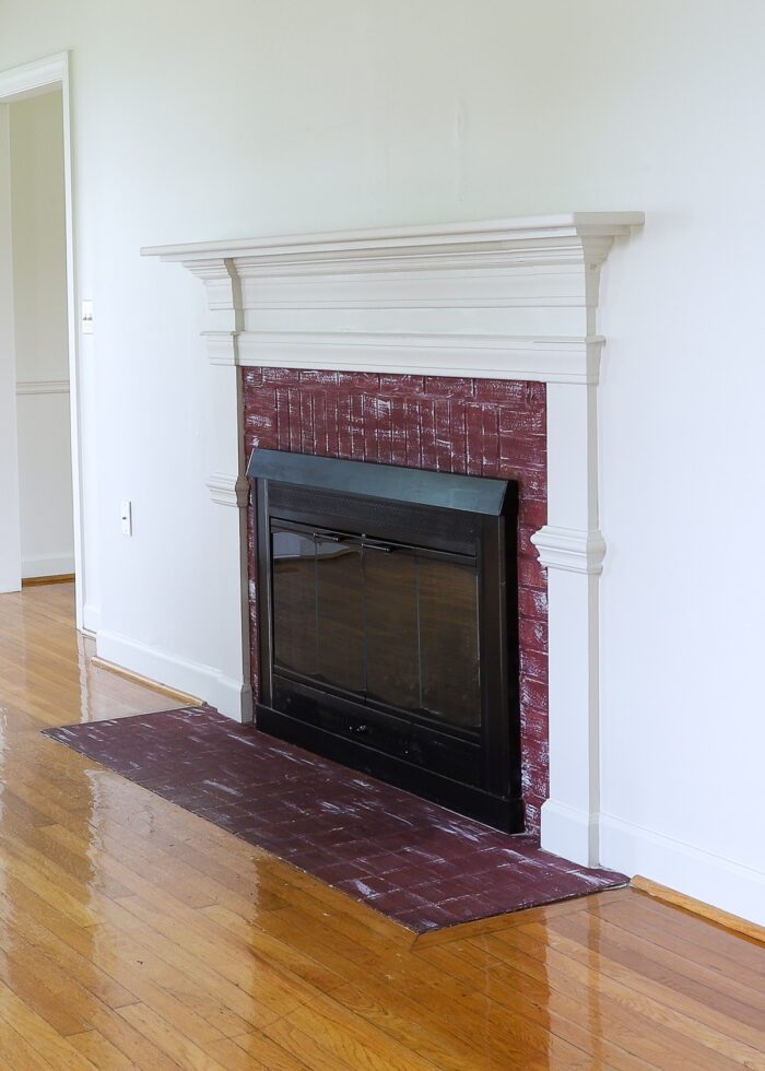 Ugly rental fireplace against a plain white wall
