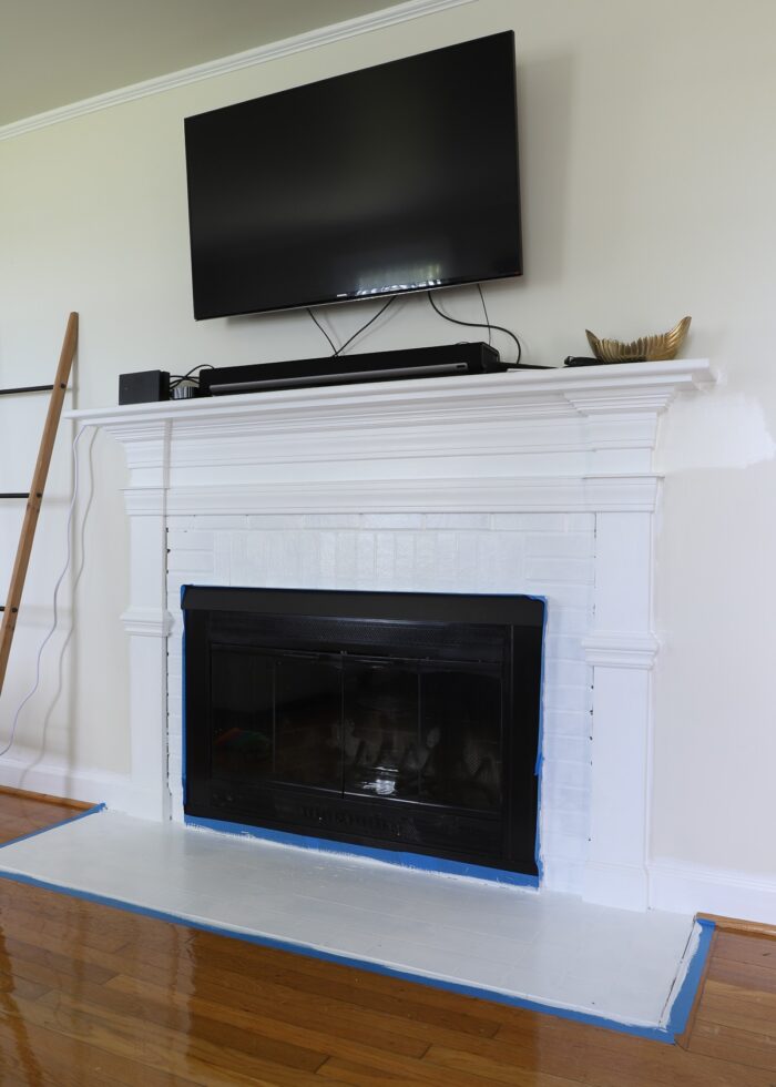 Rental fireplace bricks, hearth, and mantel painted bright white