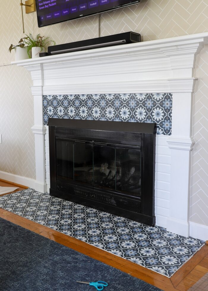 Peel and stick floor tiles on rental fireplace brick surround