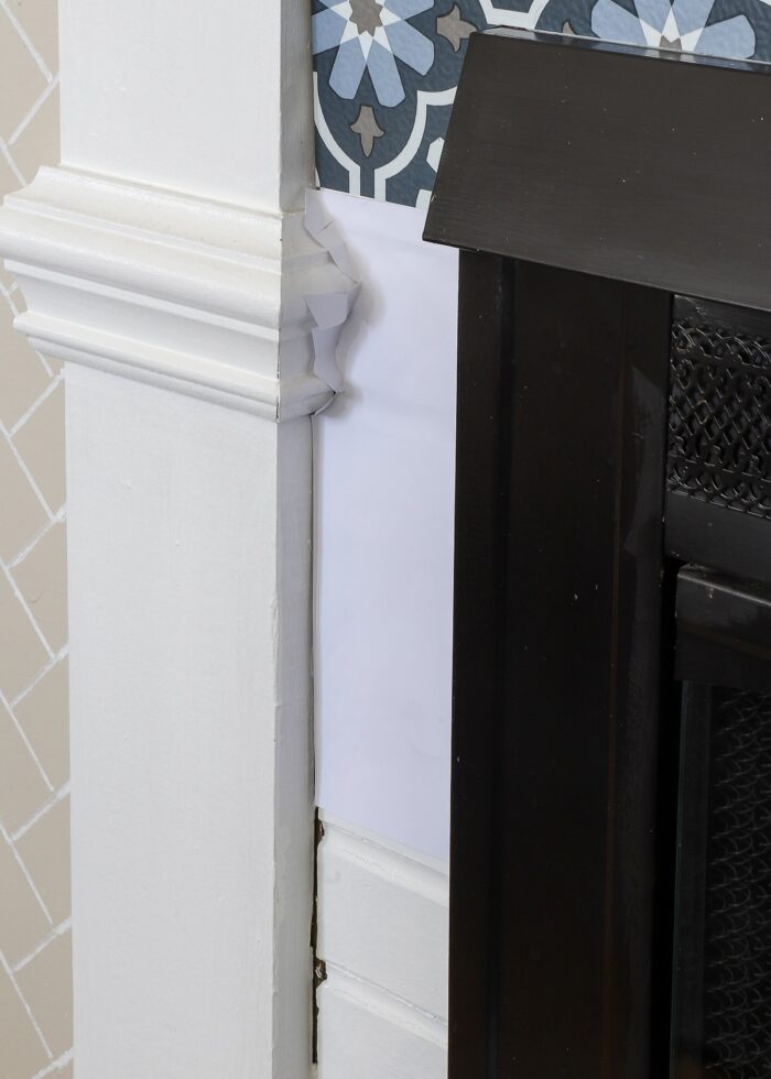 Paper template trimmed around fireplace mantel molding