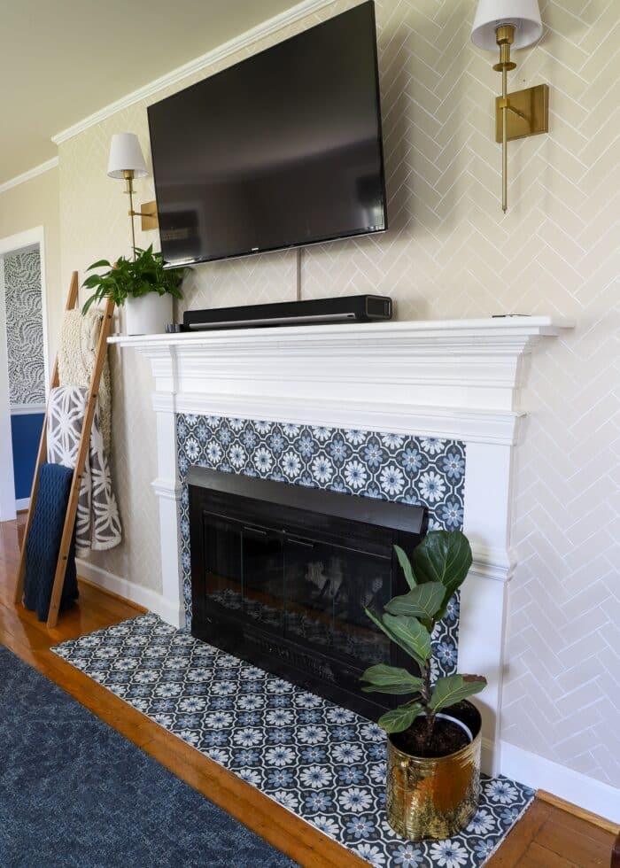 Rental fireplace with surround and hearth covered in blue and white peel and stick floor tiles