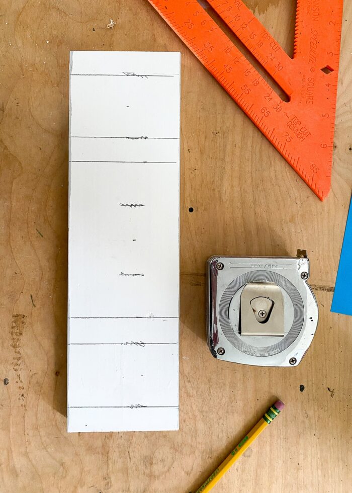 Measurements drawn onto a 12" 1x4 wood board with a tape measure