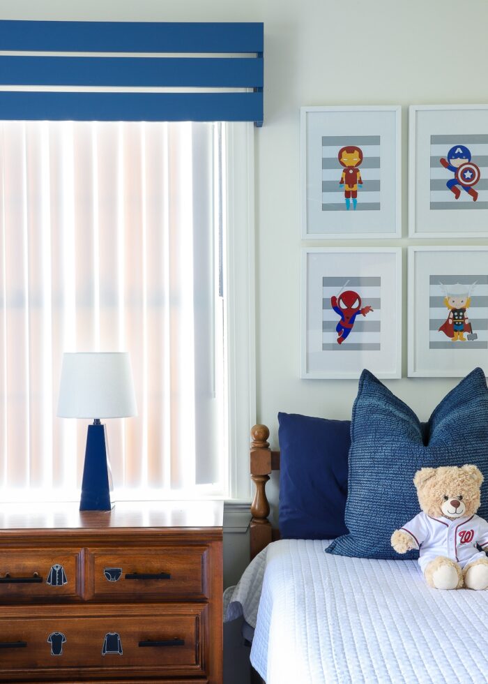 Blue and white Super Hero bedroom with a blue wooden valance on the window