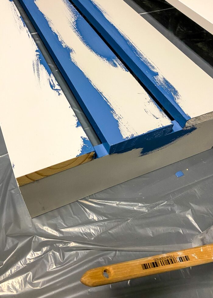 Blue paint along seems between slats on wooden valance