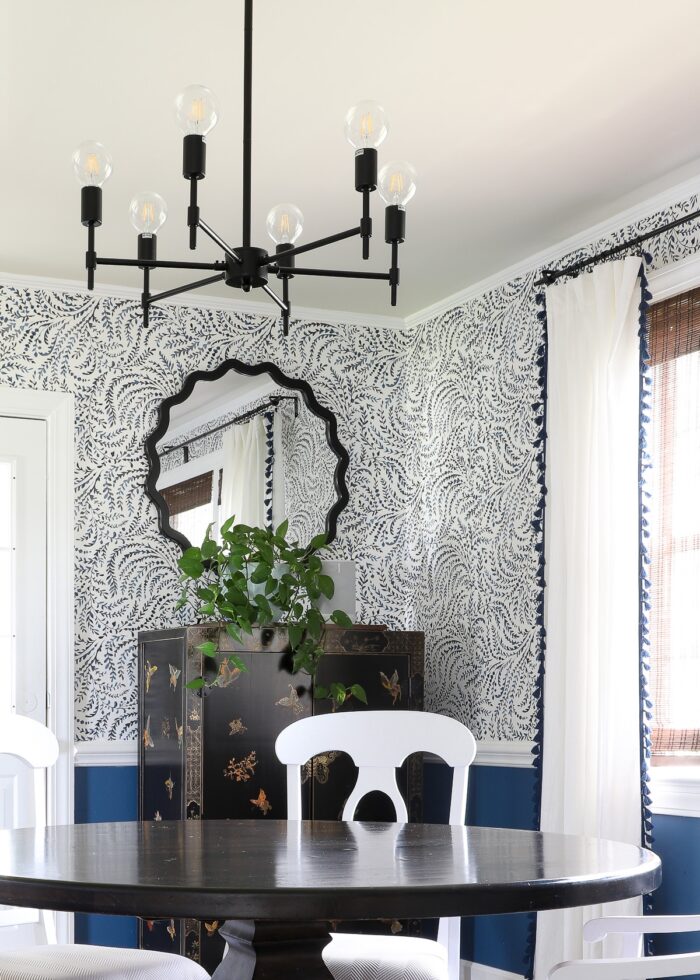 Black, blue and white rental dining room with modern matte black chandelier