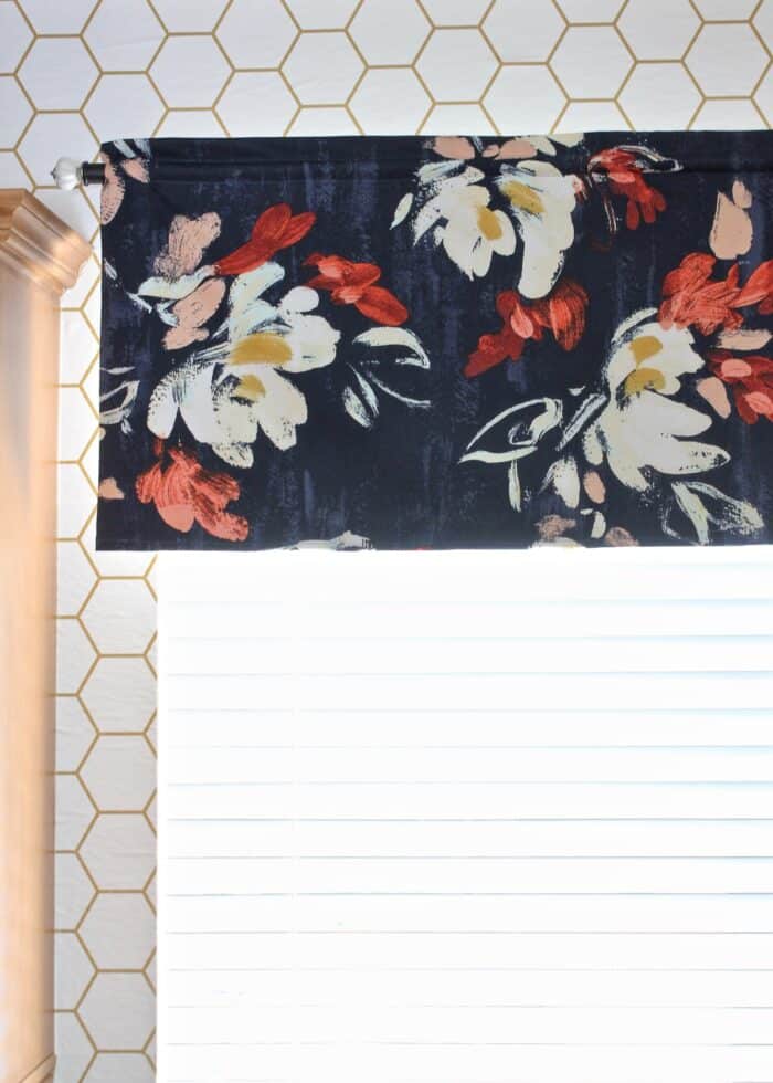 Flowered fabric valance hung on a rod