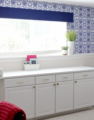 Royal blue window valance box mounted above a white countertop in a blue office