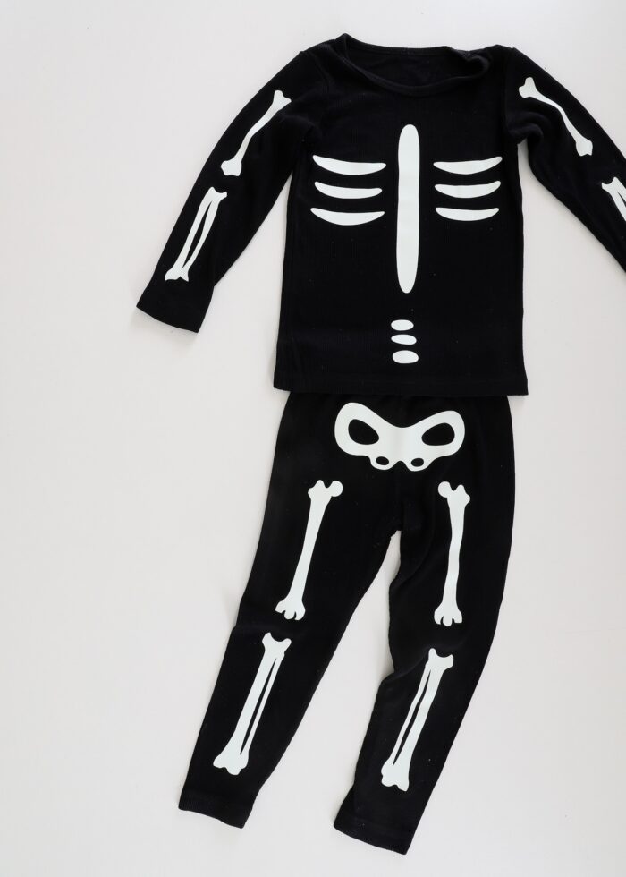Toddler skeleton costume made from iron-on vinyl and a black sweatsuit