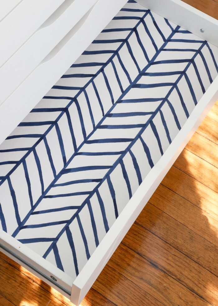 White IKEA drawer lined with blue and white contact paper