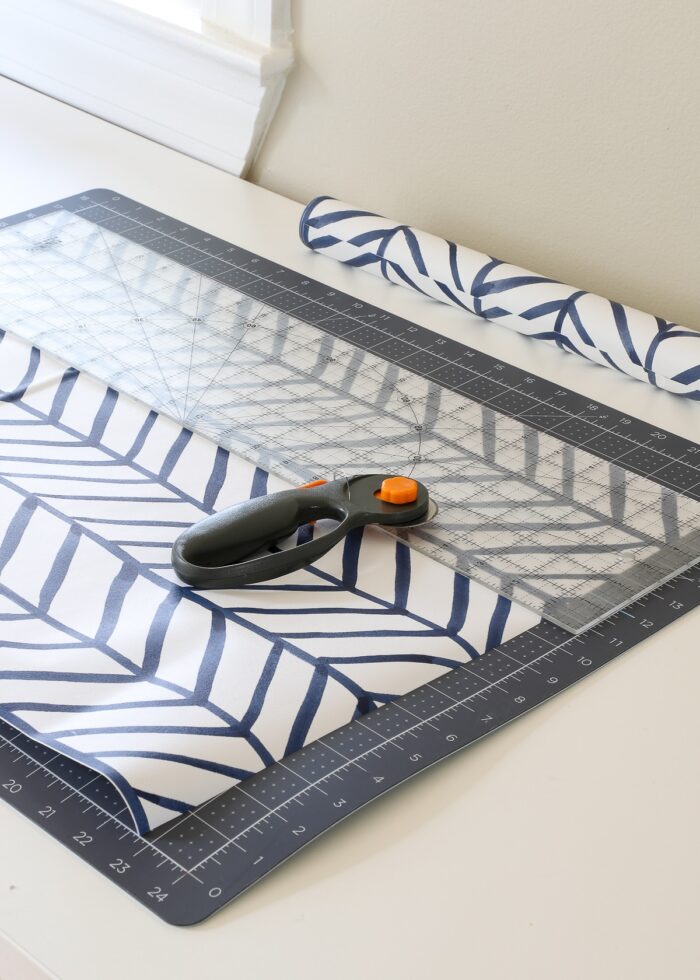 Contact paper shown on a cutting mat with ruler and rotary cutter
