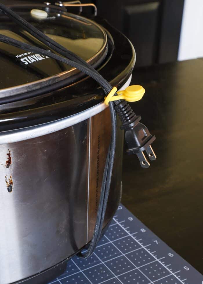 Magnetic cord ties around crockpot cord