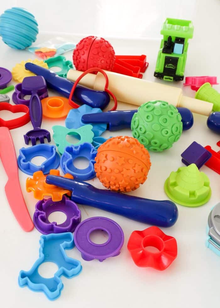 A bunch of tools, toys, molds, and cutters for Kinetic Sand