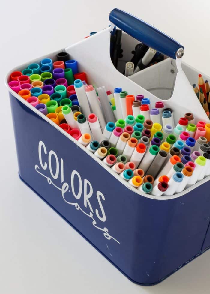 Blue utensil caddy filled with markers