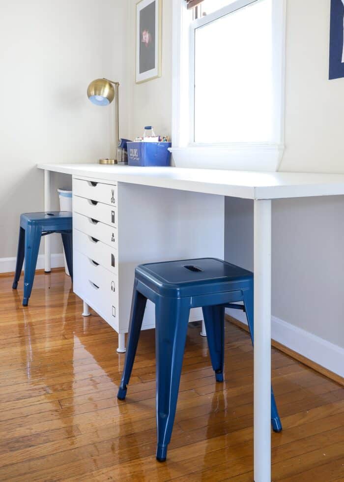 Kids art station using white drawers and desk top with two blue stools