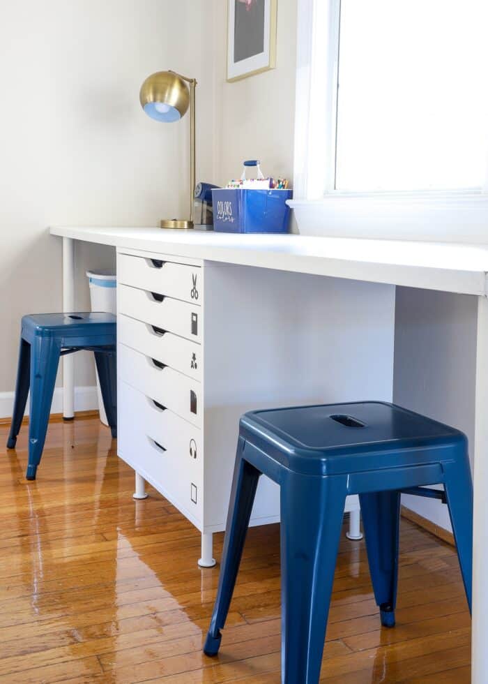Kids art station using white drawers and desk top with two blue stools
