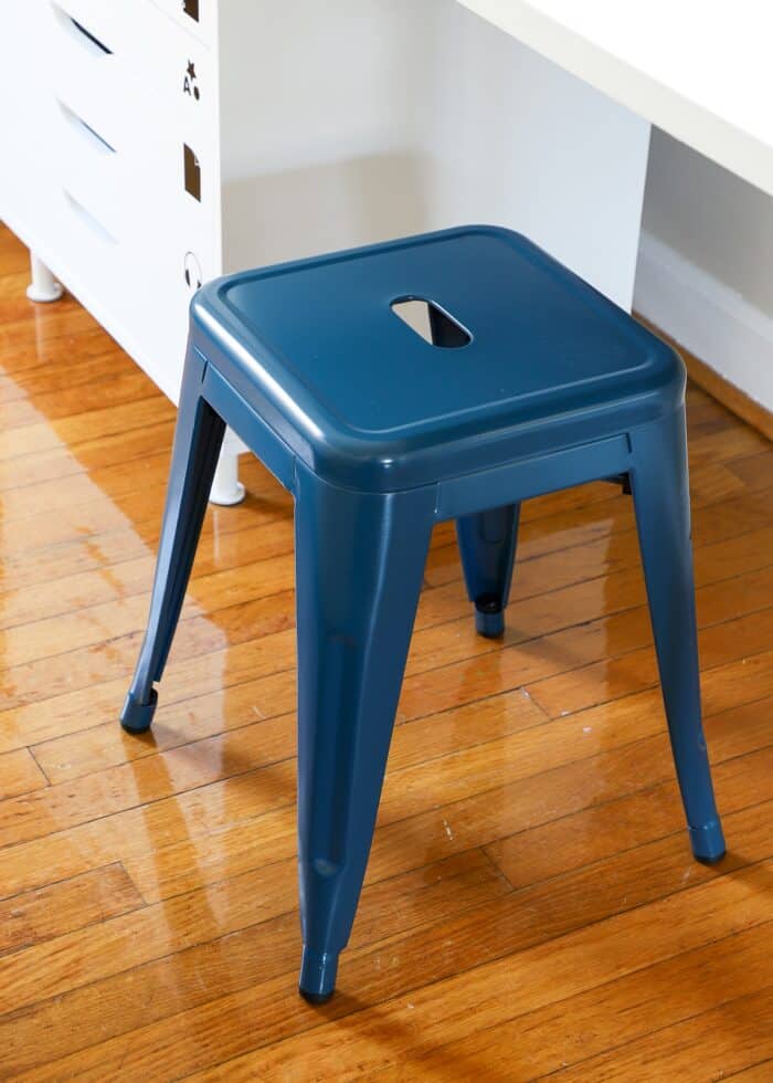 Blue metal stool at kids art table
