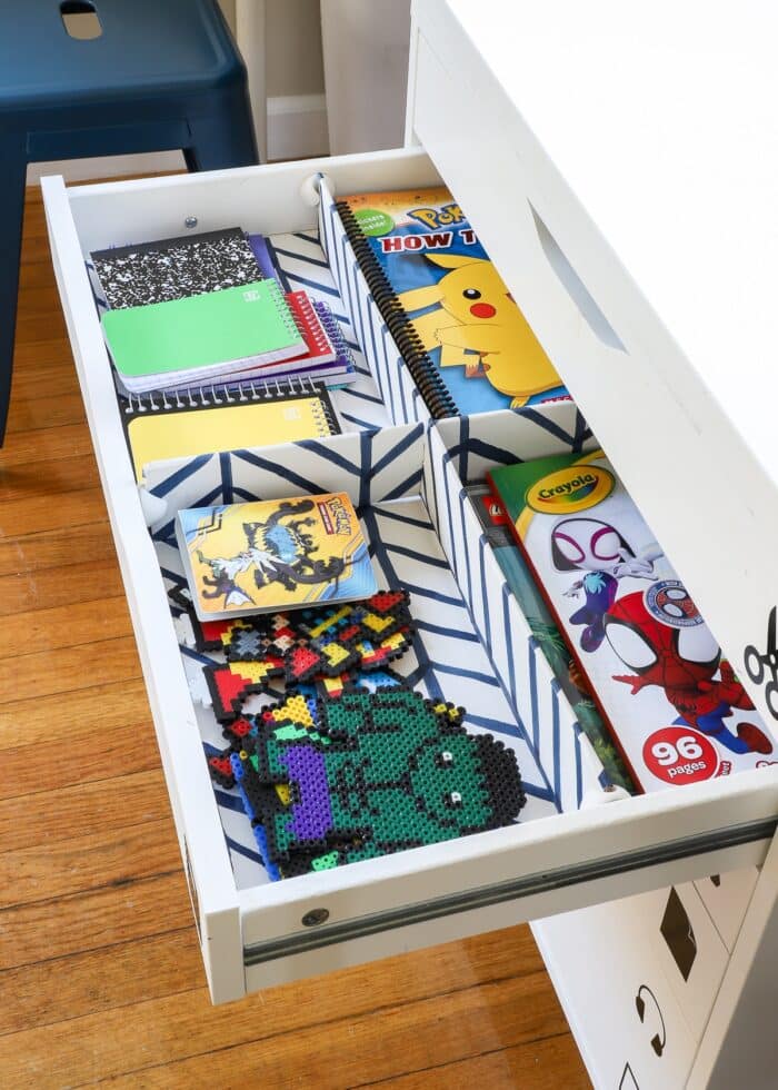 Coloring books and notebooks inside a kids art station drawer