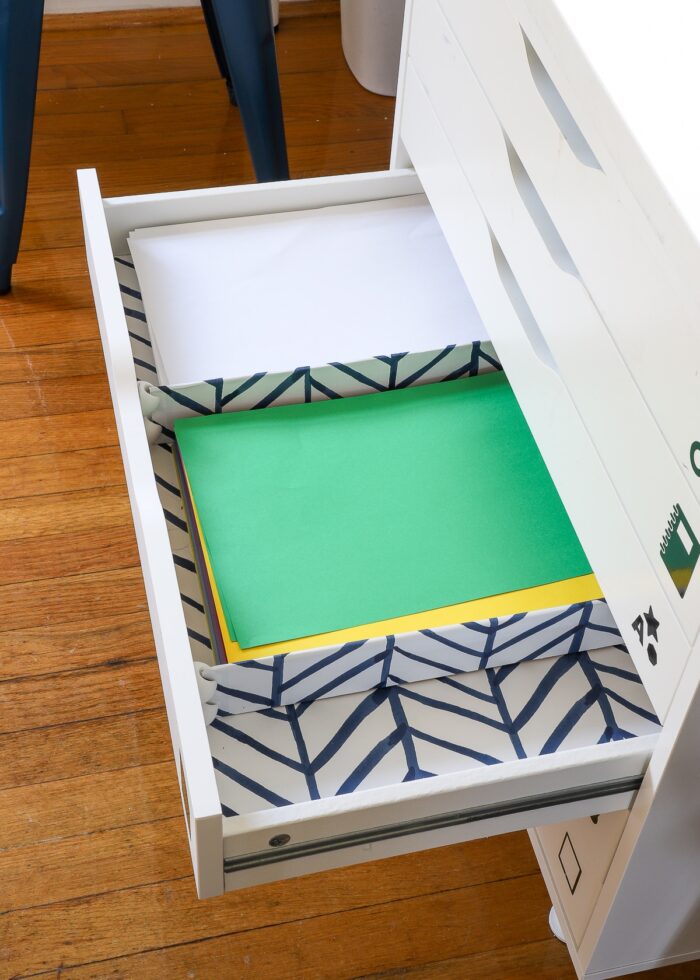 Stacks of paper inside a kids art station drawer