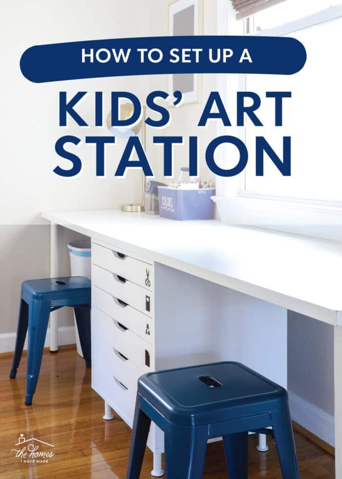 Kids art station with white drawers and desk and two blue stools