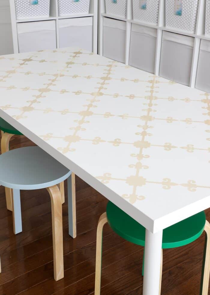Table with trellis wallpaper pattern on top