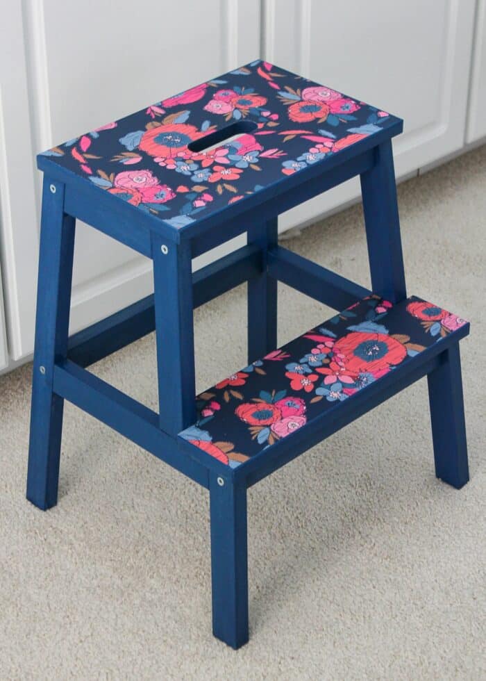 Stepping stool covered in pink and blue flowered wallpaper