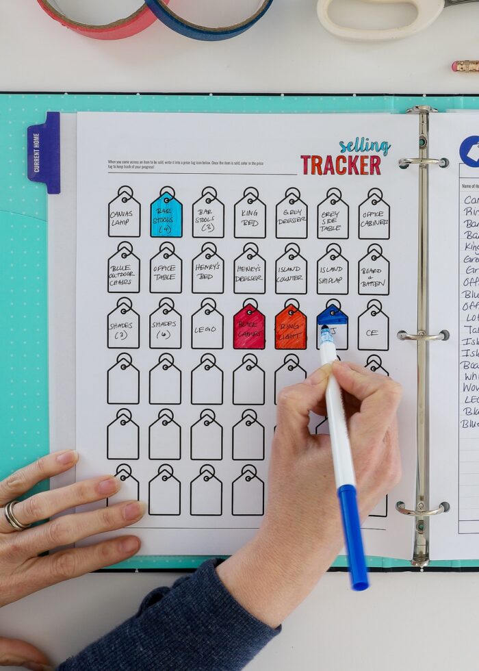Moving binder with printable selling tracker coloring page on display