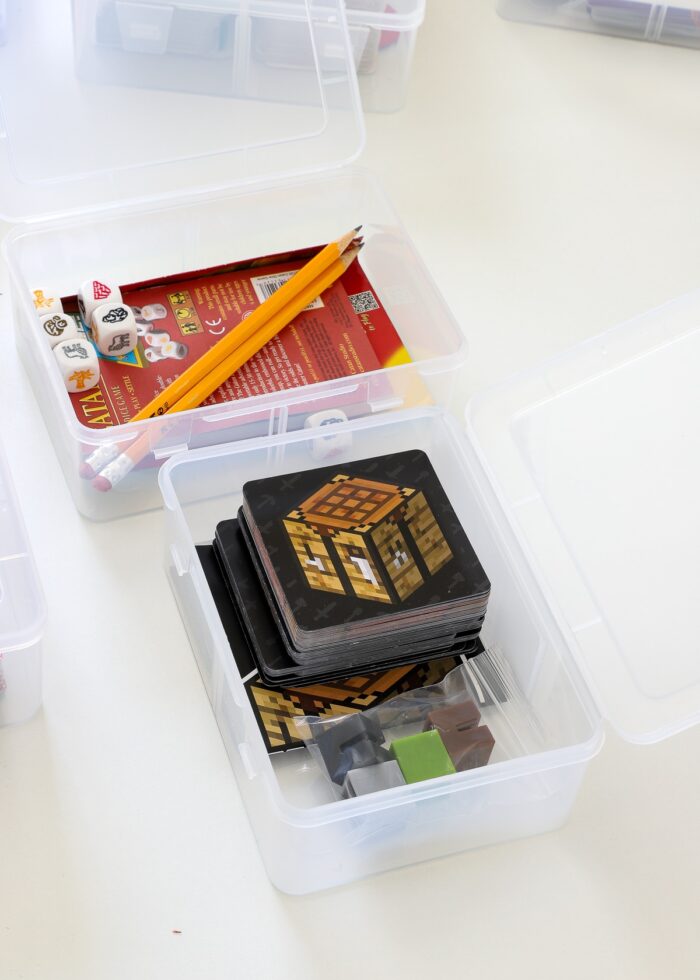 Small card games loaded into clear plastic card boxes