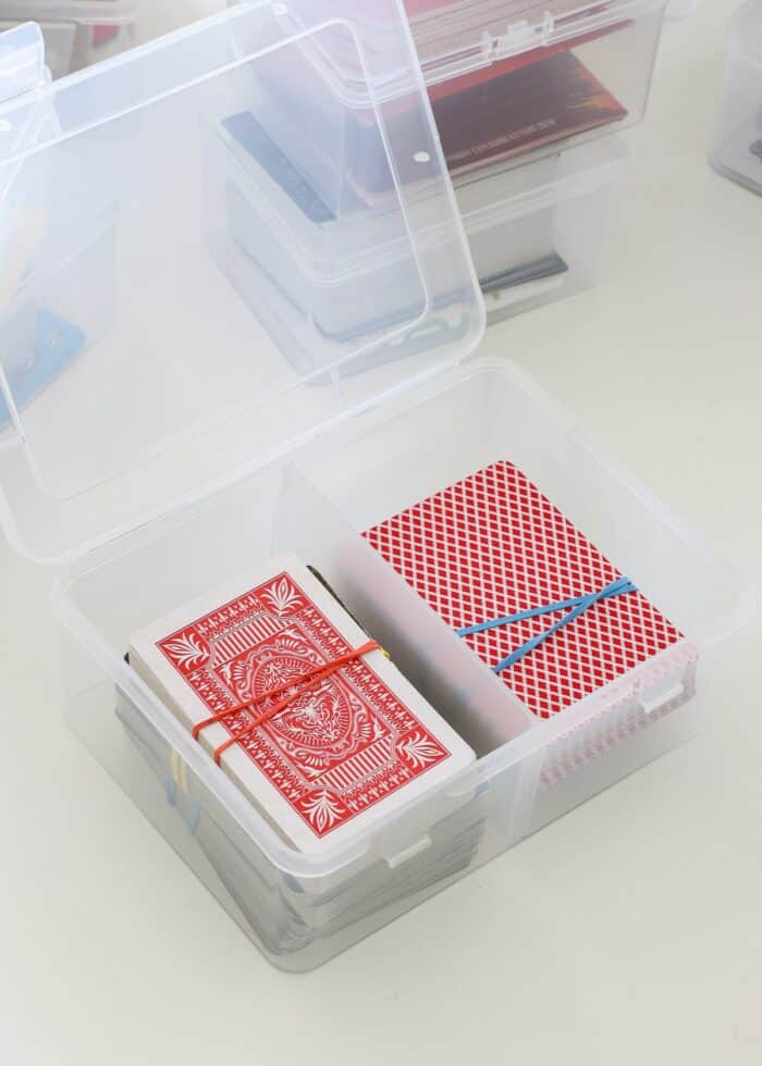 Decks of playing cards loaded into clear plastic card box