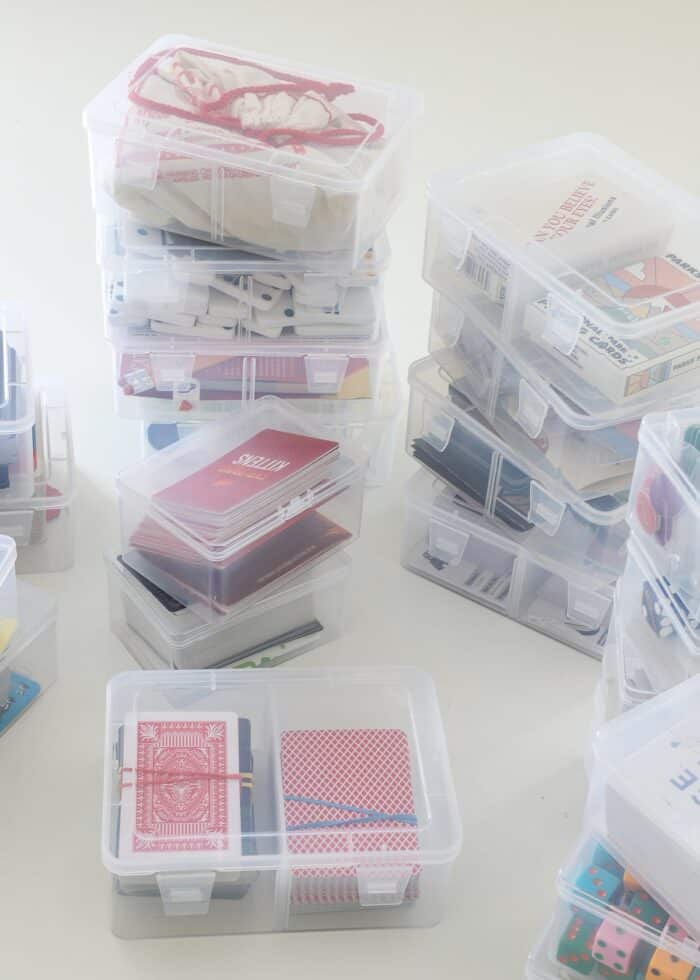 Stacks of clear card boxes holding a variety of small playing card games
