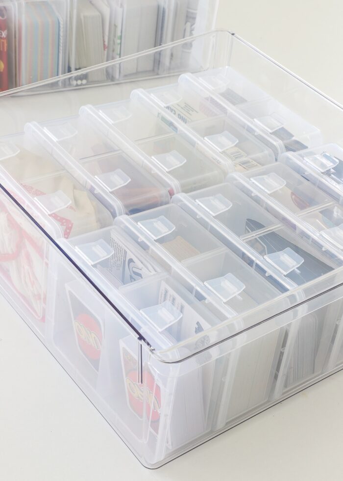 Playing card boxes loaded into a larger plastic tub