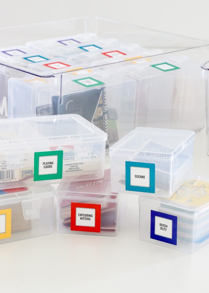 Clear playing card storage boxes with brightly colored labels