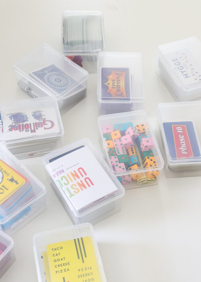 Small playing card games loaded into clear plastic card boxes