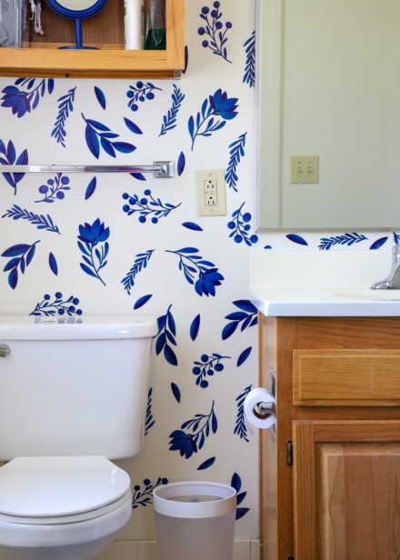 Rental bathroom decorated with blue and white flower wall decals