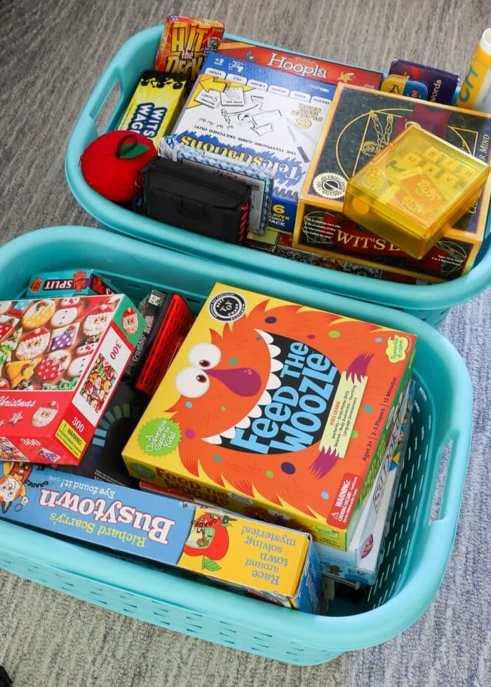 Random board games and card games loaded into baskets for donation