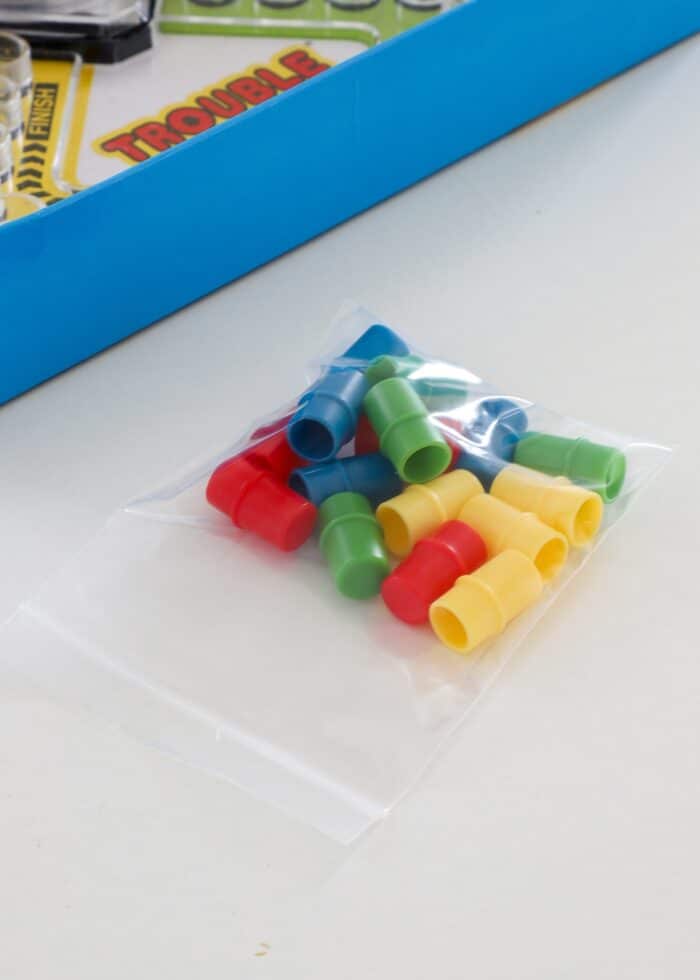 Trouble board game pieces loaded into small plastic bags