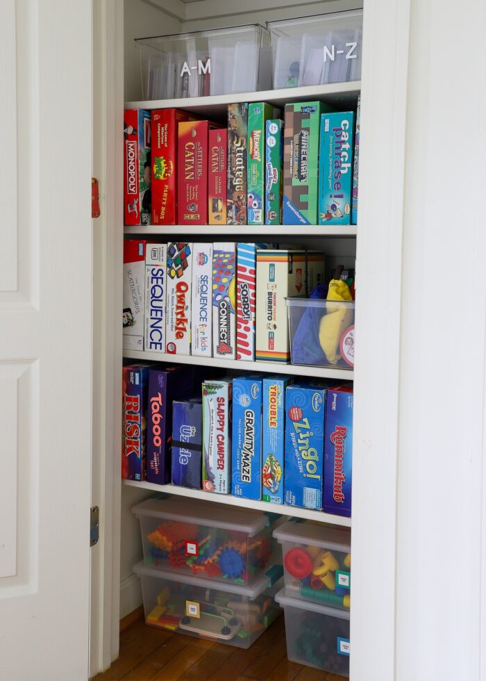 Perfectly organized game closet with games standing on their sides