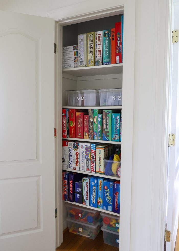 Perfectly organized game closet with games standing on their sides