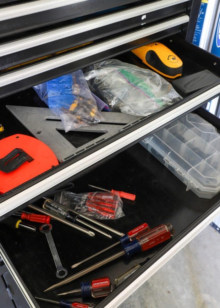 Disorganized tools in black rolling toolbox