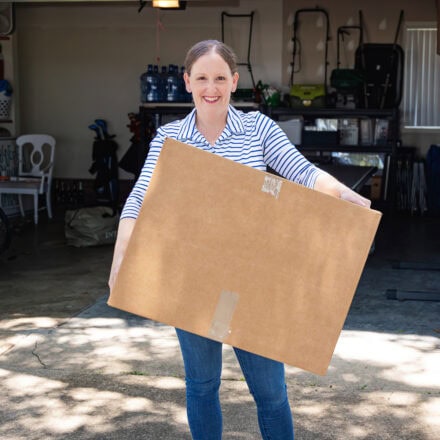 Megan carrying a moving box